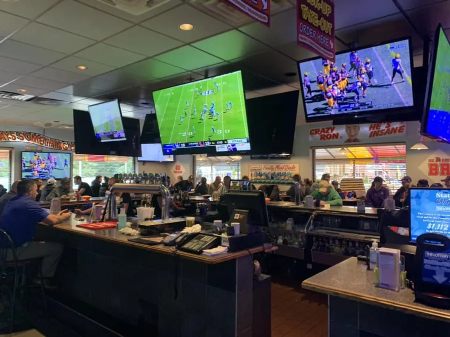 The bar and dining room with the game on the TVs