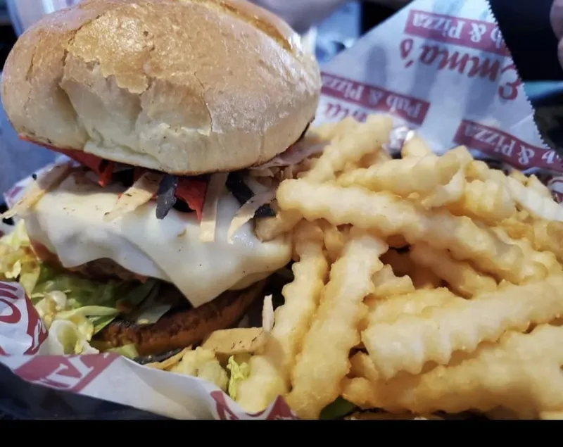 Burger with crinkle-cut fries in a branded basket