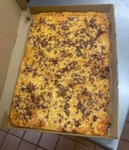 Sheet pan pizza in a take-out box