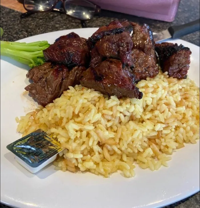 Marinated steak tips over rice